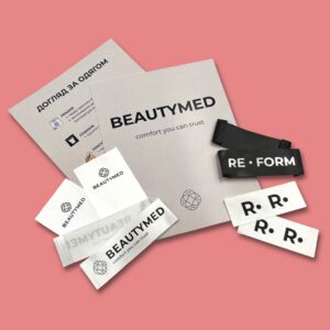 Custom satin clothing labels with Beautymed and Reform logos