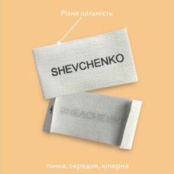 Бавовняна етикетка з чорним написом SHEVCHENKO, що демонструє різну щільність матеріалу: тонку, середню та кіперну.