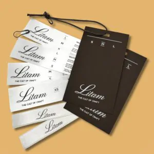 Білі тканинні етикетки та коричневі паперові бирки "Litam".