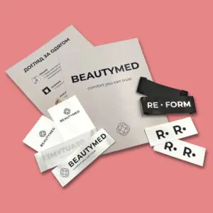 Custom satin clothing labels with Beautymed and Reform logos