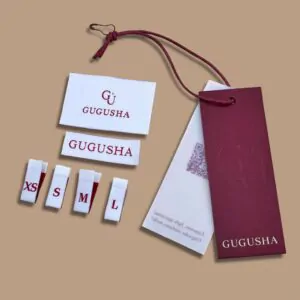 White woven labels and size tags with GUGUSHA logo