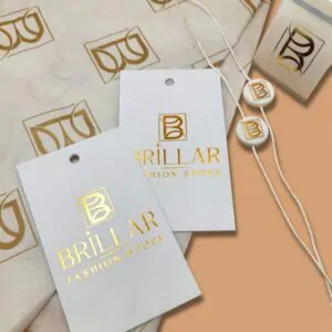 Білі паперові бірки та етикетки з золотим логотипом BRILLAR